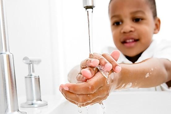 Boy washing his hands