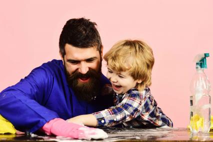 Man and child cleaning a table together