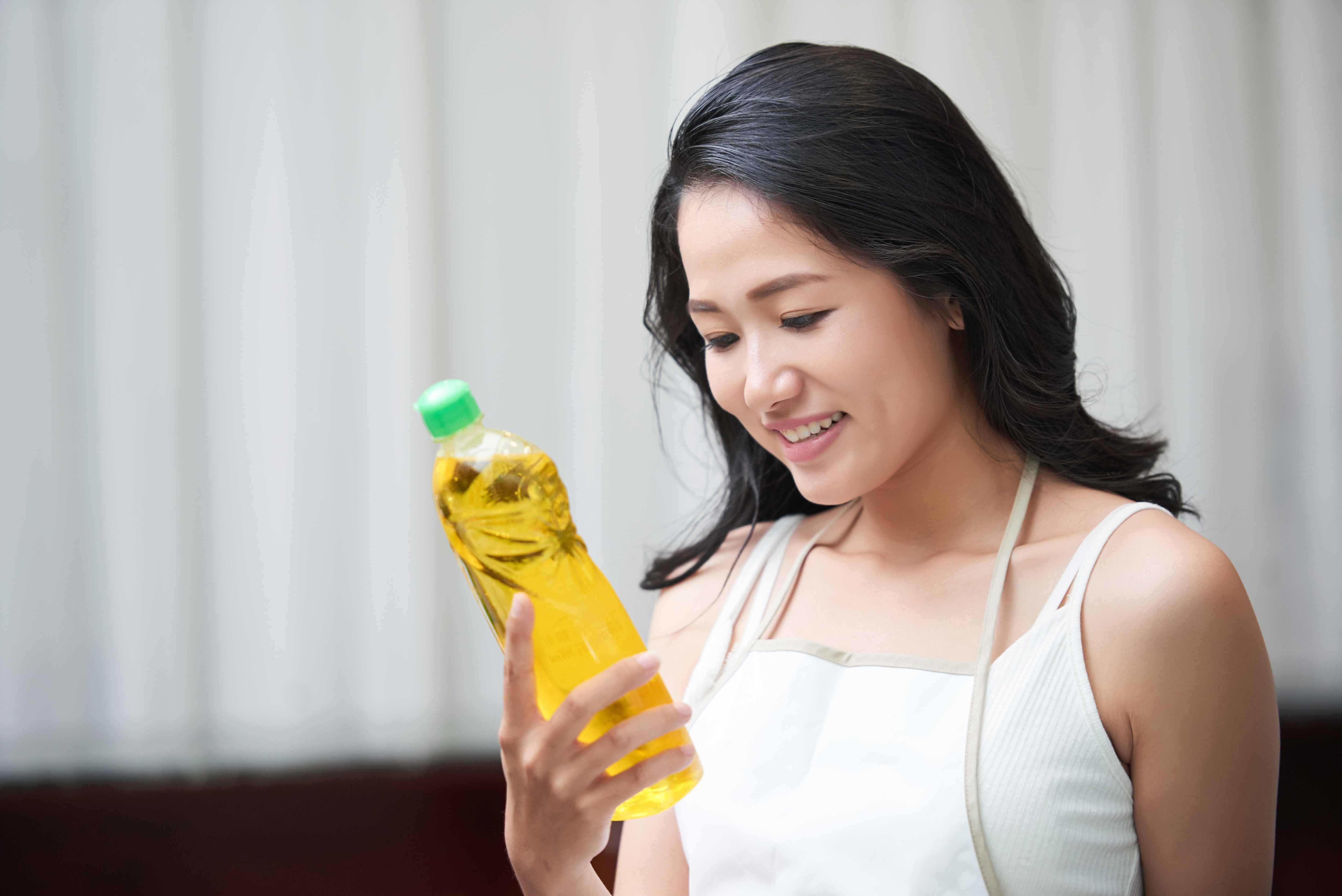 Woman checking cleaning product label