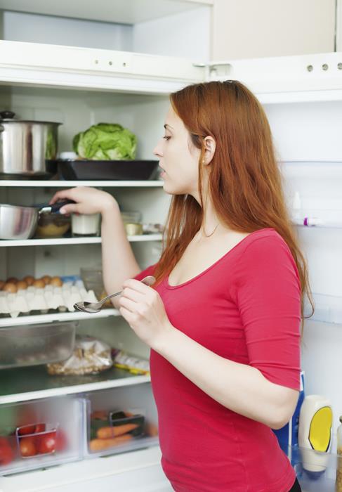 woman and open refrigerator