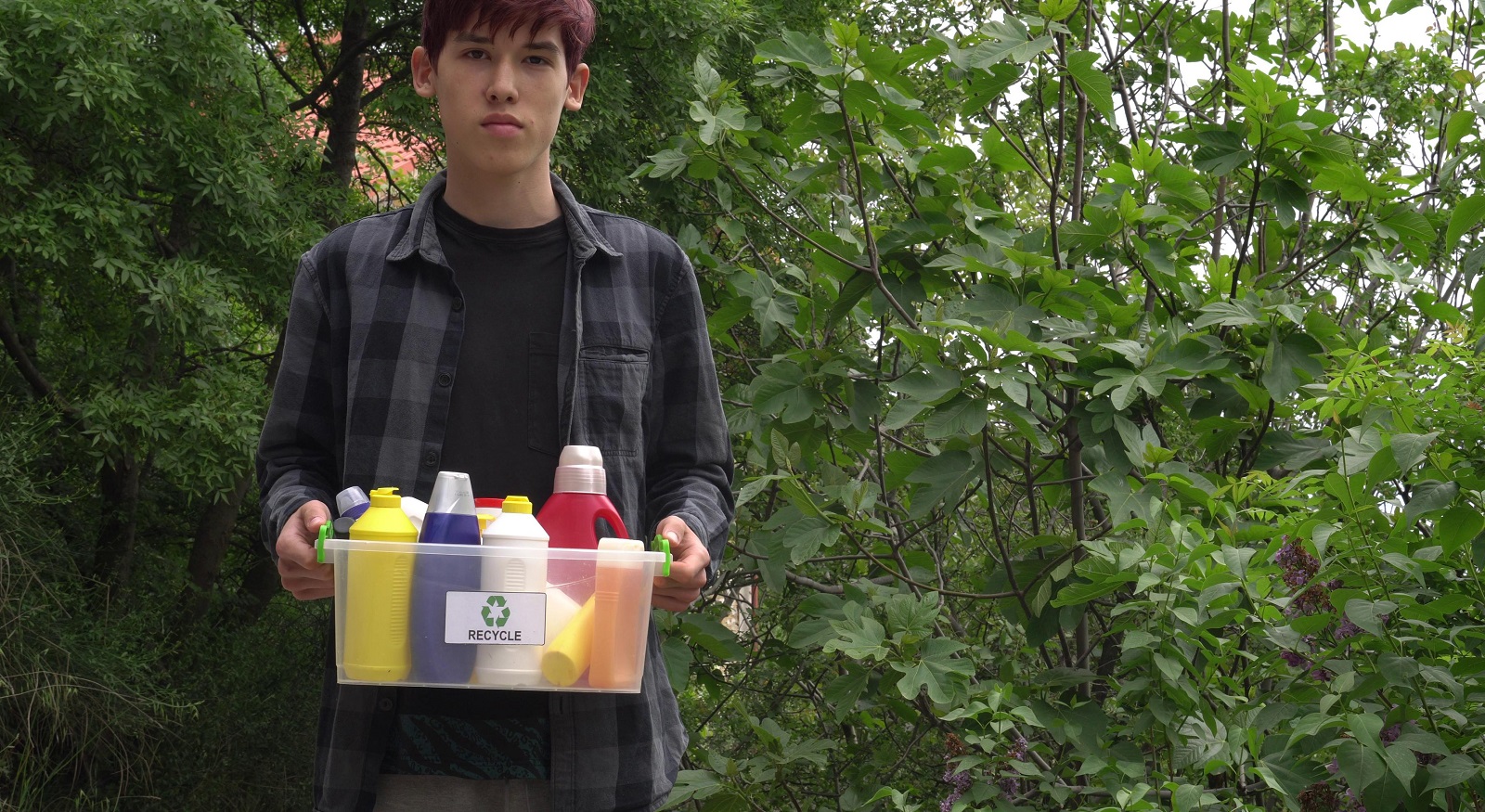 boy recycling cleaning products
