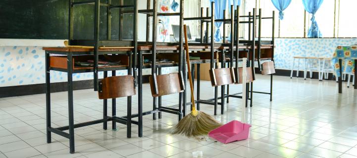 Mop and bucket near a row of desks