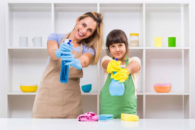 Woman and child pointing spray bottles at the camera