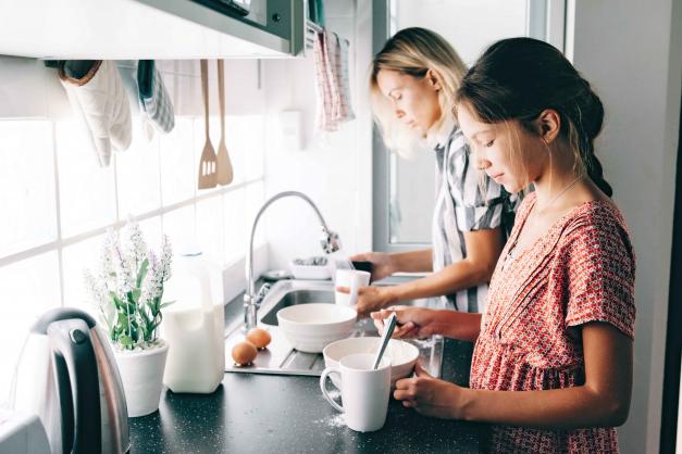 Adult and child washing dishes