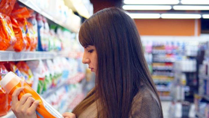 Woman Reading Bottle Label