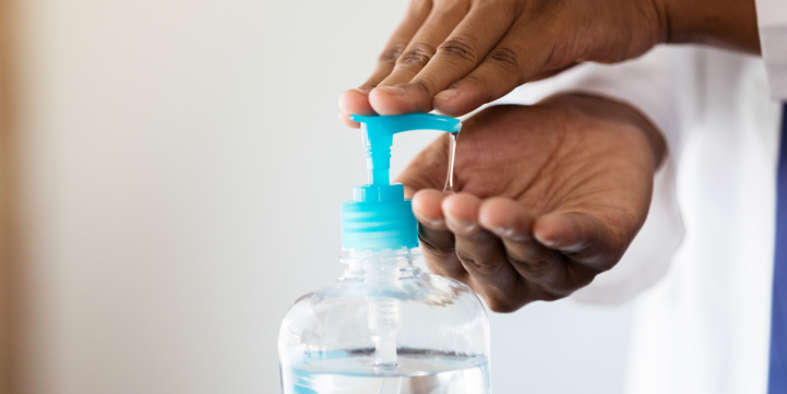 health care provider using hand sanitizer