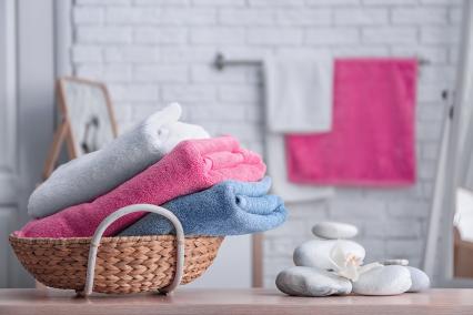 A basket of towels on a bathroom counter