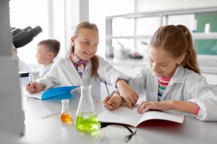Kids in lab coats doing a science experiment